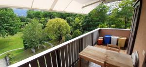 a balcony with a table and a view of trees at Il Giardino in Colico +3 photos