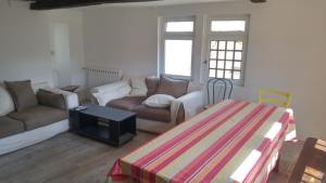 a living room with a couch and a table at Hostel du lapin blanc in Saint-Brieuc