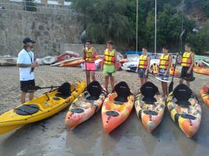 a group of children in life jackets standing next to kayaks at La Sort Boutique Hotel in Moraira