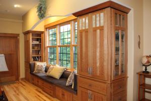 a room with a large wooden cabinet and a couch at Inn at the River in Wausau