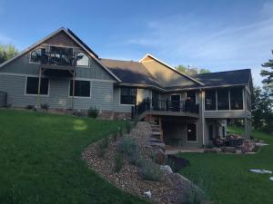 a house with a balcony and a yard at Inn at the River in Wausau