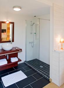 y baño con ducha y lavamanos. en Logis Hôtel Vent d'Iroise en Plougonvelin