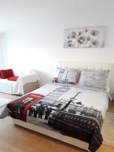 a bedroom with a bed with a military blanket on it at APARTMAN MMVG STUDIO Zagreb Airport in Velika Gorica