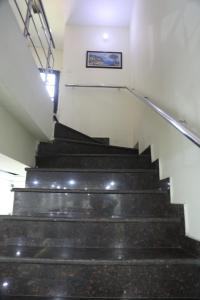 a set of stairs in a building with a picture on the wall at Time Square Guest House in Jalandhar