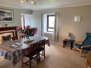 a living room with a table with flowers on it at 18 Cross Skigesrta Road in Swanibost