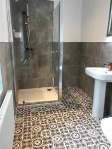 a bathroom with a shower and a sink at Bush House Accommodation - The Diamond in Bushmills