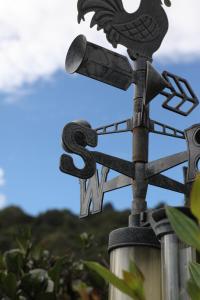 a street sign with a bird on top of a pole at Maleny Hinterland Escape in Witta