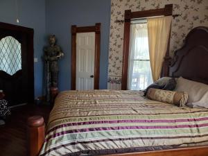 a bedroom with a large bed and a window at 1890 Karcher Haus in Llano