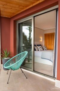 a room with a bed and a chair on a balcony at La Ola in Tazacorte