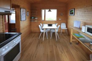 a kitchen and dining room with a table and chairs at Cozy Cottage by Stay in Iceland in Hvolsvöllur