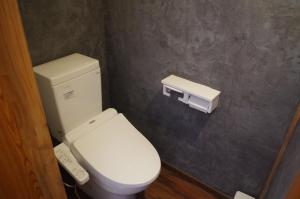 a bathroom with a white toilet in a room at Kusatsu Onsen Guesthouse Gyoten in Kusatsu +19 photos