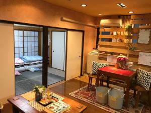 a living room with a table and a dining room at Koi Koi in Takamatsu