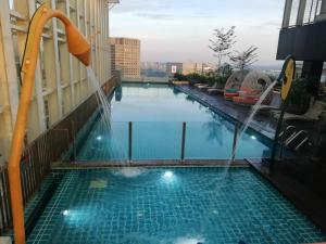 a swimming pool on the side of a building at Suasana JB at JB Center Luxury Modern & Rustic 1BR Apt for Bussiness,Vacation trips in Johor Bahru +14 photos