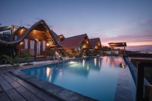 a swimming pool in front of a house at Daphila Cottage in Nusa Penida