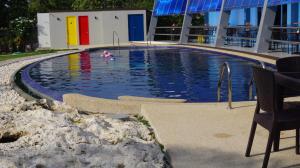 a person swimming in a swimming pool on a building at Panglao Sea Resort - Tangnan in Panglao