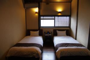 Posteľ alebo postele v izbe v ubytovaní Rokusho-an
