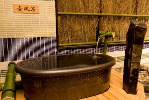 a bath tub with a water fountain in a room at Dormy Inn Premium Kyoto Ekimae Natural Hot Spring in Kyoto