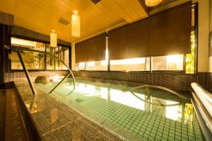 a swimming pool in a building with a pool at Dormy Inn Premium Kyoto Ekimae Natural Hot Spring in Kyoto