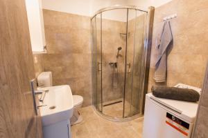 a bathroom with a shower and a toilet at Putnik in Dugi Rat +14 photos
