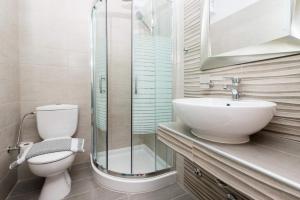 a bathroom with a toilet and a glass shower at Hotel Stefanos in Chrysi Ammoudia