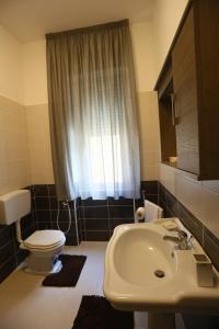 a bathroom with a toilet and a sink at Civico7 in Villa San Giovanni