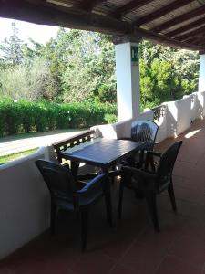a table and chairs sitting on a patio at White Sand Residence in Murta Maria