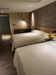 Ένα ή περισσότερα κρεβάτια σε δωμάτιο στο City Suites - Taoyuan Station