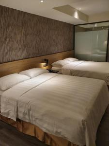 Ένα ή περισσότερα κρεβάτια σε δωμάτιο στο City Suites - Taoyuan Station +37 φωτογραφίες