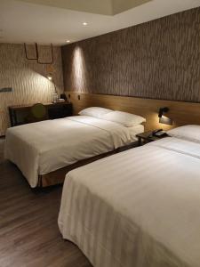 เตียงในห้องที่ City Suites - Taoyuan Station