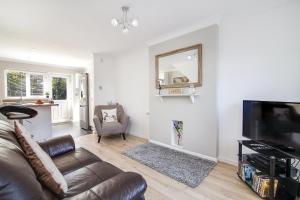 a living room with a couch and a television at Westmorland House in Tamworth