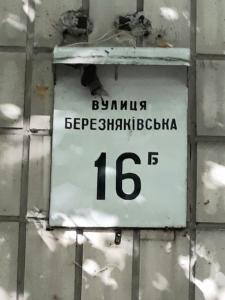 a sign on the side of a brick wall at Apartment Telbin in Kyiv