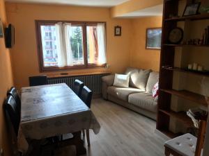 a living room with a table and a couch at Apartamento céntrico en Formigal in Formigal