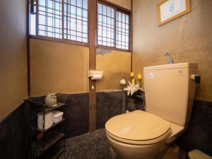 a bathroom with a white toilet in a room at 内子の宿 こころ in Uchiko