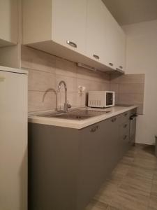 a kitchen with a sink and a microwave at Apartment Gabrijela in Split