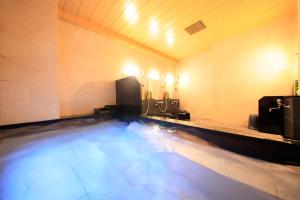 a swimming pool with blue water in a room at Smile Hotel Kawaguchi in Kawaguchi