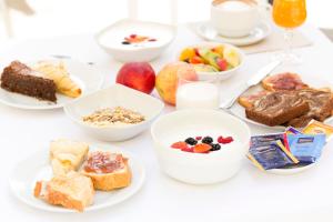 a table topped with plates of breakfast foods at Residence Villa Maurice in Stresa