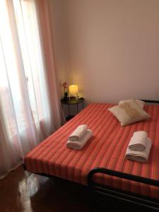 a bedroom with a bed with towels on it at Turtle harbour Seafront Apartment! Full Seaview!!! in Argostoli