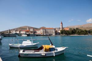 two boats are docked in a body of water at Villa Donna in Trogir