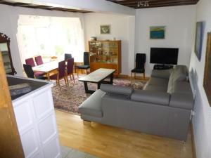 a living room with a couch and a table at Panoramaferienhaus Sorpesee in Sundern