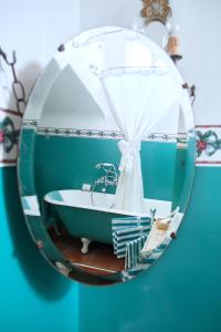 a bathroom with a bath tub in a mirror at Villa Fausta B&B in Trieste