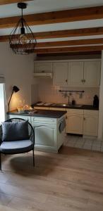 a kitchen with a table and a chair in a room at Gästewohnung Wasserzucht in Wunstorf +29 photos