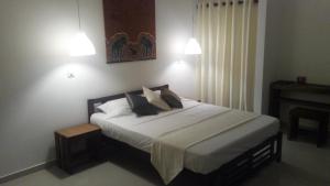 En eller flere senge i et værelse på Colibri Villa