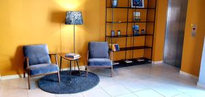 a waiting room with two chairs and a table at Hotel Plaza in Pag