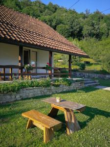 a picnic table in the grass in front of a building at Holiday Home Nektar Park in Bihać