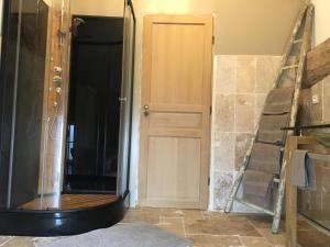 a shower with a glass door in a room at Domaine Des Tours Vauquelin in La Fresnaye-au-Sauvage +37 photos