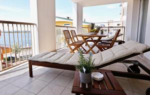 a living room with a couch and a table on a balcony at Hotel & Apartments Eldorado in Grado