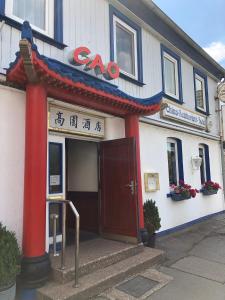 a building with a door in front of it at Hotel Cao in Hemmingen