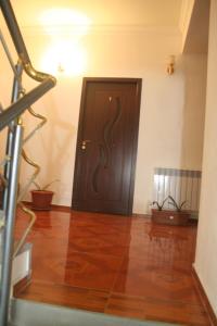 a wooden door in a room with a wooden floor at Hotel Noy in Goris