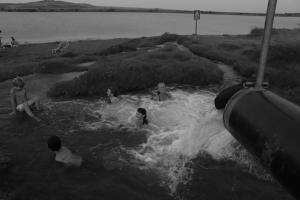 a group of people sitting in the water at Healing Hands in Merom Golan