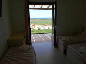 A bed or beds in a room at Il giardino dei tramonti
